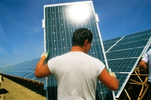 Mies asentaa aurinkopaneeleja Leipzigissa Saksassa. Kuva © National Geographic Stock/ Sarah Leen / WWF.